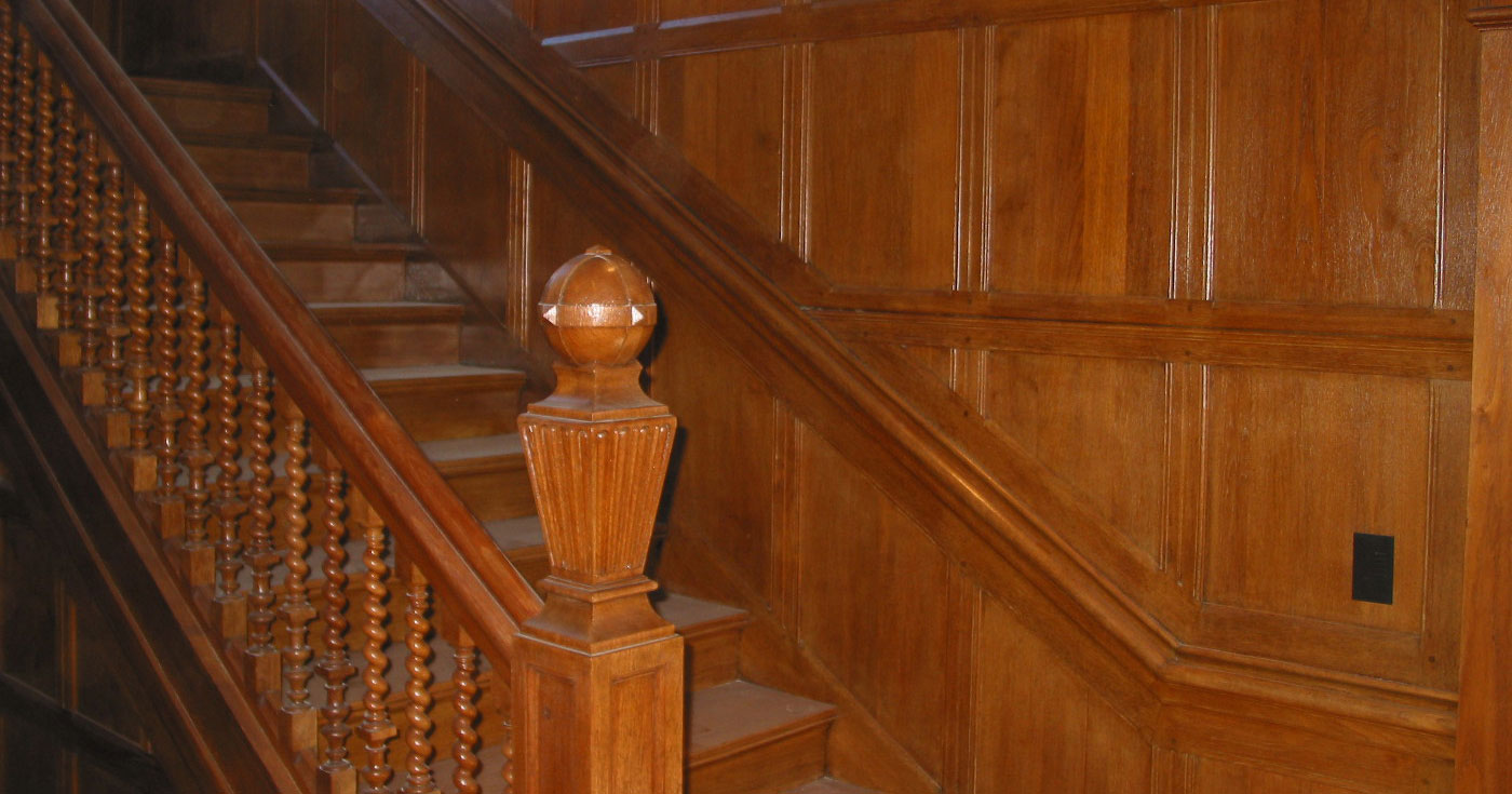 A wooden staircase with handrails