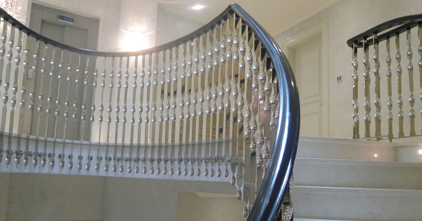 A modern staircase with a sleek metal rail
