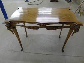 Antique table with intricate carvings on top