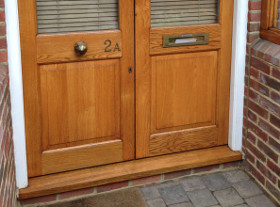 A wooden door with a glass panel